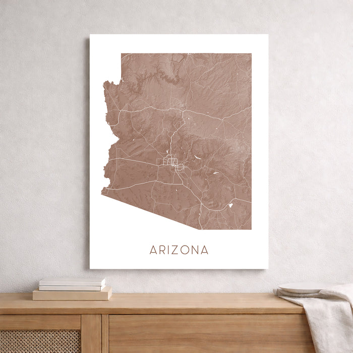 Framed map of Arizona on a wall above a wooden shelf.