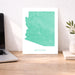 Map of Arizona on a desk with a laptop and plant