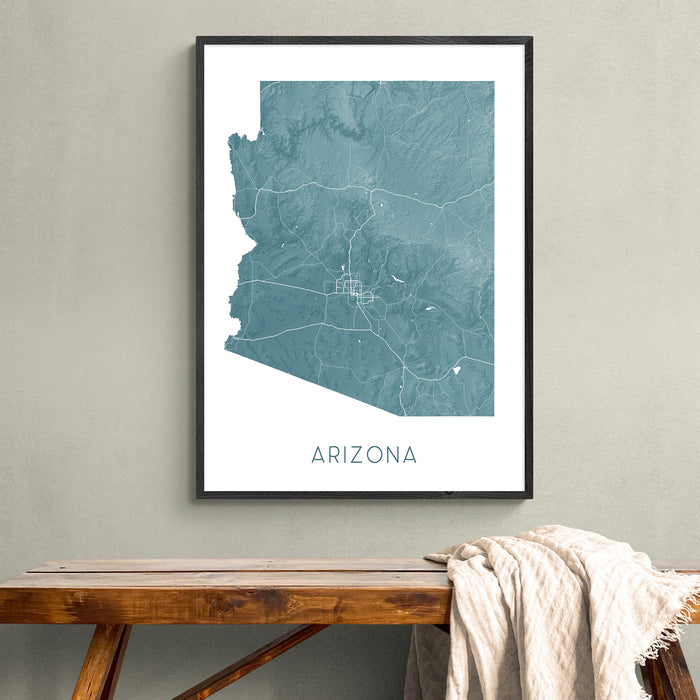 Framed map of Arizona on a wall above a wooden bench.