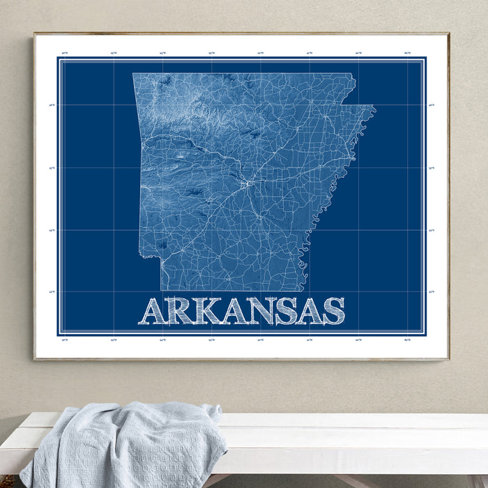 Framed map of Arkansas on a wall above a white surface.