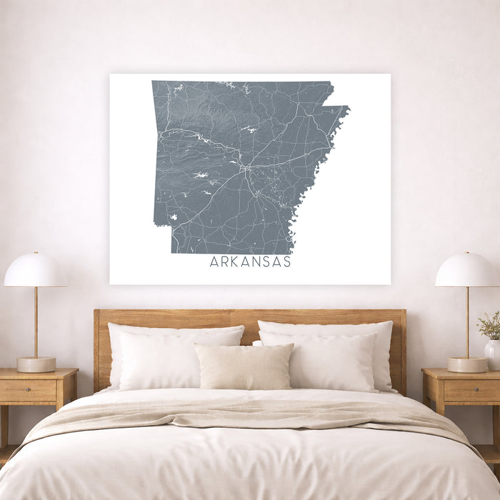 Map of Arkansas on a wall above a bed in a bedroom setting
