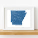 Framed map of Arkansas on a white wall