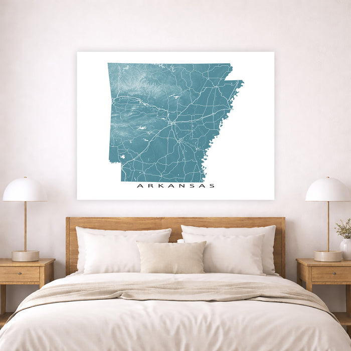 Map of Arkansas on a wall above a bed in a bedroom setting