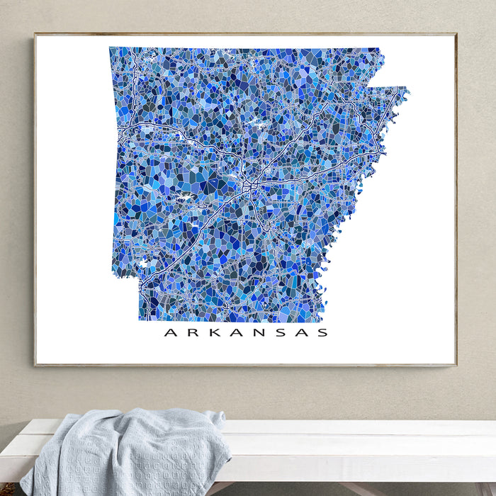 Framed map of Arkansas with a blue mosaic pattern on a beige wall.