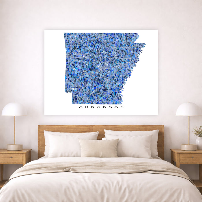 Map of Arkansas on a wall above a bed in a bedroom setting