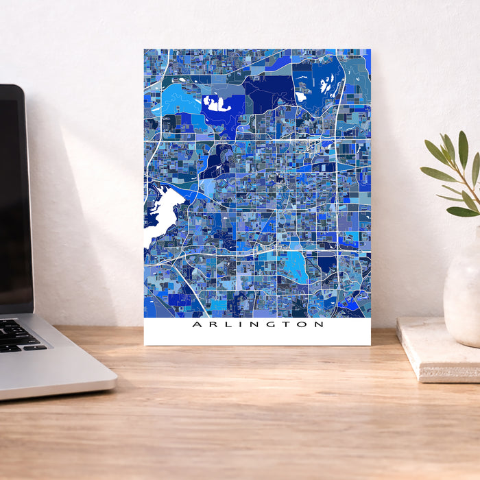 Map of Arlington on a desk with a laptop and plant