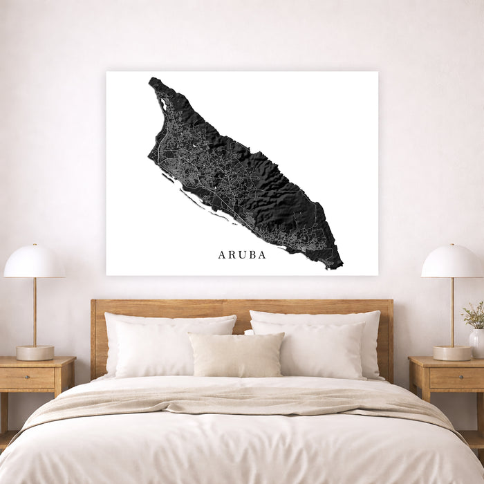 Map of Aruba on a wall above a bed in a bedroom setting