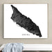 Framed map of Aruba on a wall above a white surface.