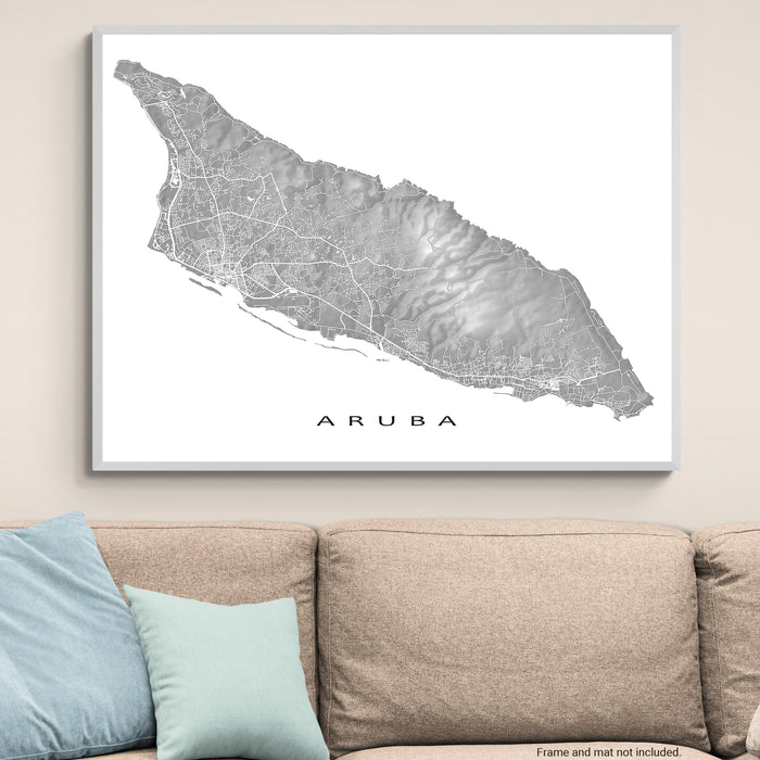 Framed map of Aruba on a wall above a sofa