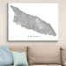 Framed map of Aruba on a wall above a sofa