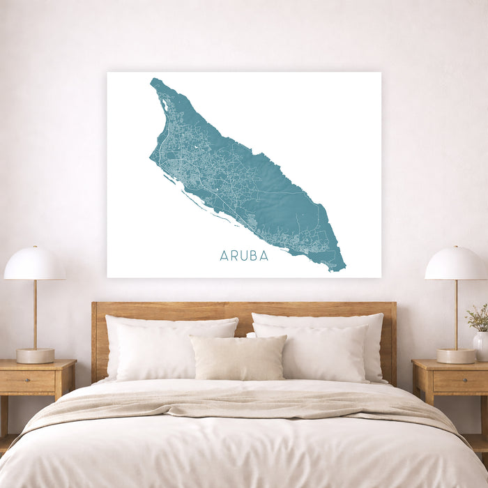 Map of Aruba on a wall above a bed in a bedroom setting