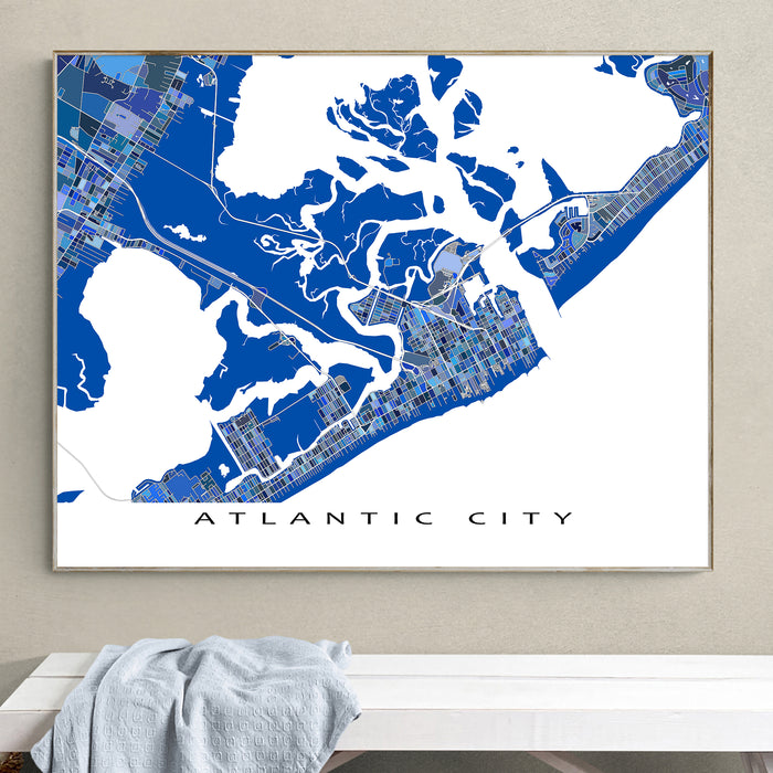 Framed map of Atlantic City on a wall above a white bench.