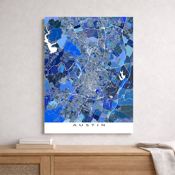 Map of Austin in blue tones on a white wall above a wooden surface.