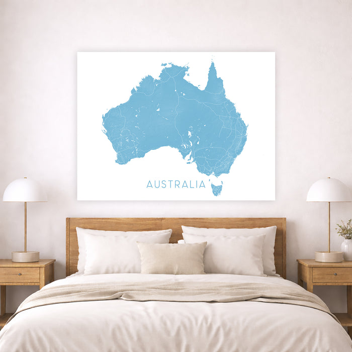 Map of Australia on a wall above a bed in a bedroom setting