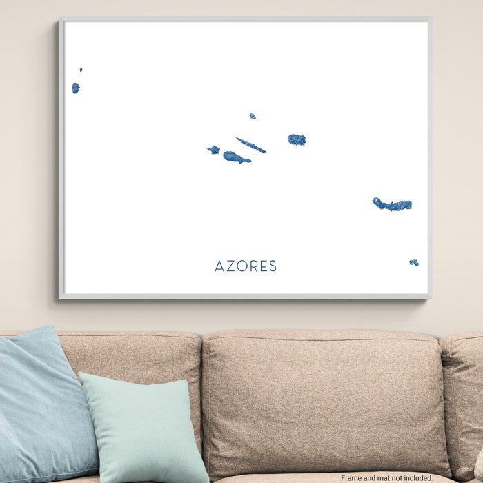 Framed map of the Azores on a wall above a sofa.