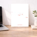 Laptop on a desk with a decorative paper featuring 'Azores' text and a plant in the background.