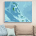 Map of The Bahamas on a wall above a beige sofa with light blue pillows.