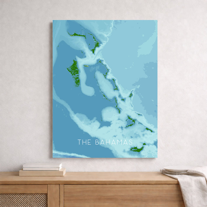 Map of The Bahamas on a blue background, framed and leaning against a wall.