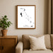 Framed map of The Bahamas on a wall above a sofa with a plant beside it.