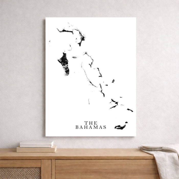 Map of The Bahamas on a white wall above a wooden shelf.