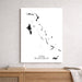 Map of The Bahamas on a white wall above a wooden shelf.