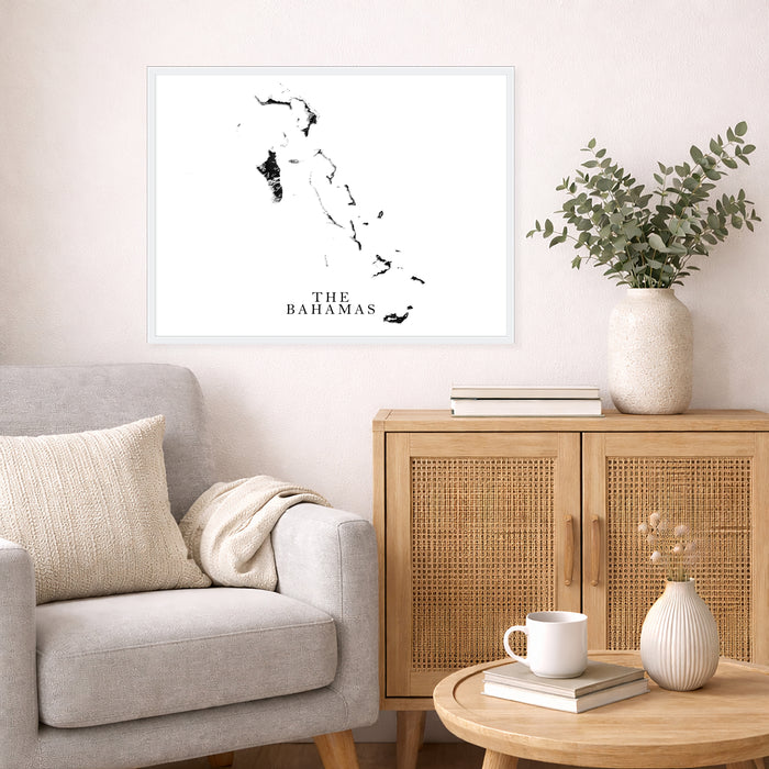Living room with a map of The Bahamas on the wall, a gray sofa, wooden cabinet, and small table.