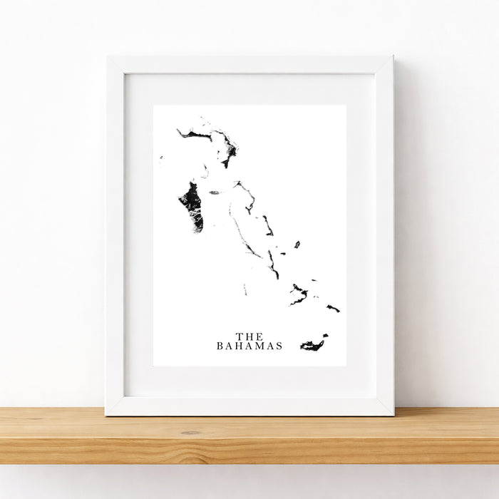 Framed black and white map of The Bahamas on a white wall.