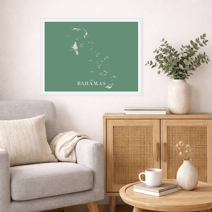Living room with a map of The Bahamas on the wall, a gray sofa, wooden cabinet, and decorative items.
