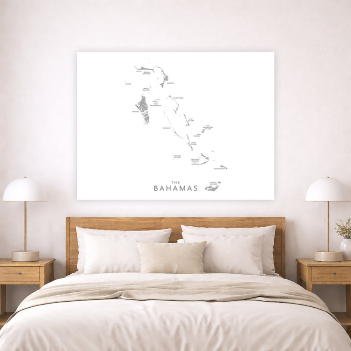 Bedroom with a map of The Bahamas on the wall above a bed.