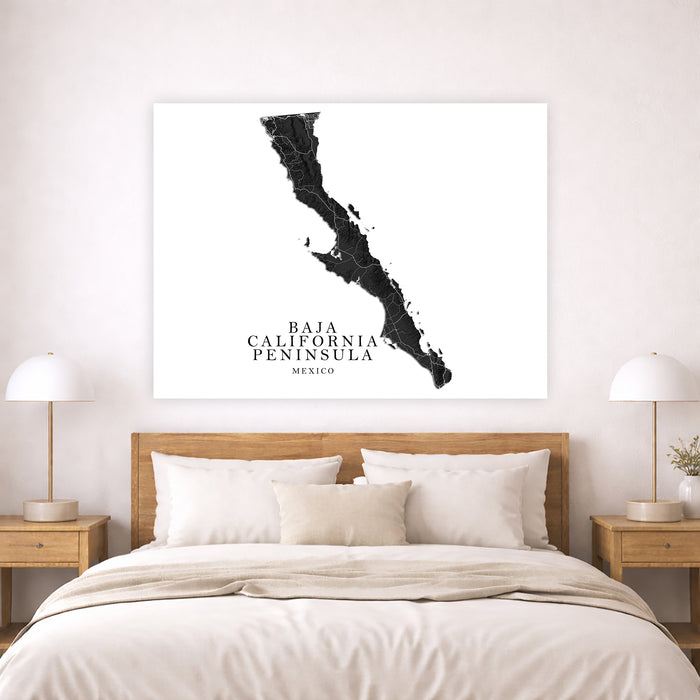Map of Baja California Peninsula on a wall above a bed in a bedroom.