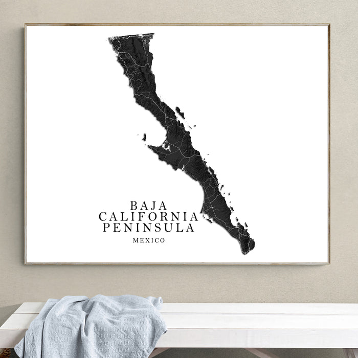 Framed map of Baja California Peninsula on a wall above a white bench.