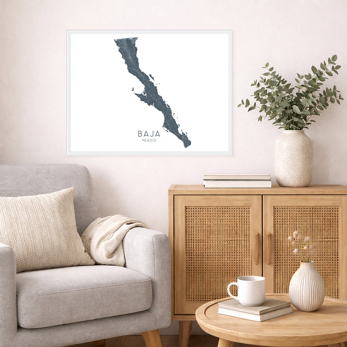 Living room with a map of Baja California, a vase with plants, and a wooden cabinet.