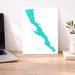 Map of Baja California on a desk with a laptop and plant