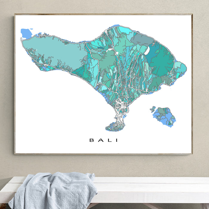 Framed map of Bali on a wall above a white bench.
