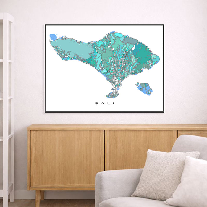Map of Bali framed on a wall above a wooden cabinet in a living room.