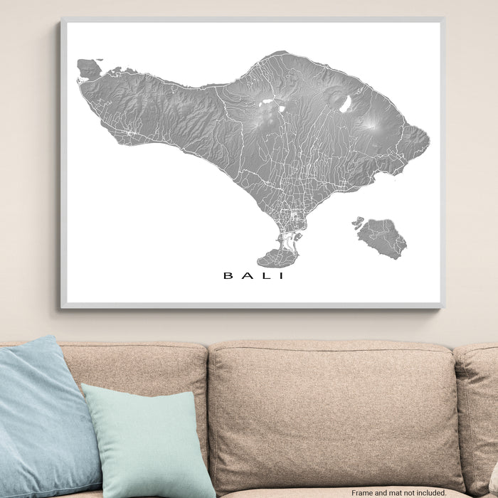 Framed map of Bali on a wall above a sofa