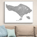 Framed map of Bali on a wall above a sofa