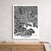 Framed black and white map of Baltimore on a wall above a wooden surface.