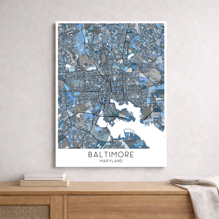 Framed map of Baltimore, Maryland on a wall above a wooden surface.
