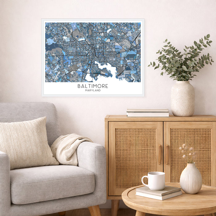 Living room with a city map of Baltimore on the wall, a beige armchair, wooden cabinet, and decorative items.