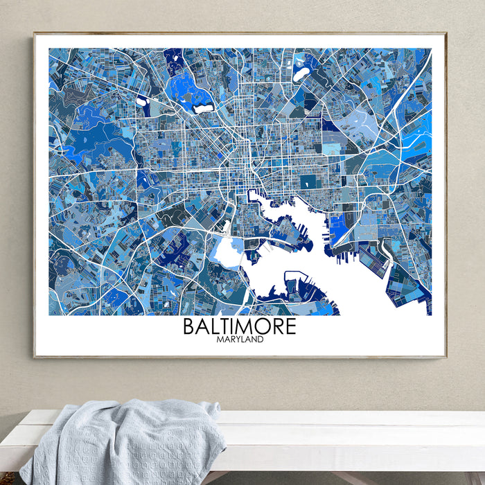Framed map of Baltimore, Maryland on a wall above a white surface.