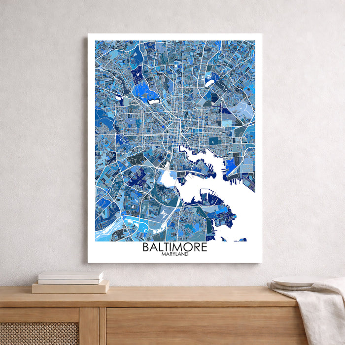 Framed map of Baltimore, Maryland on a wall above a wooden surface.