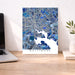 Map of Baltimore on a wall above a desk with a laptop and plant.