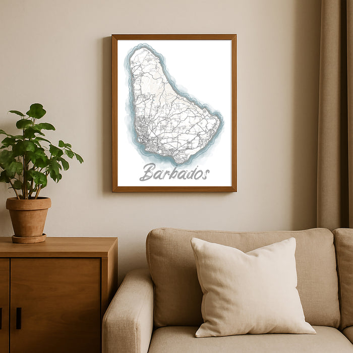 Framed map of Barbados on a wall above a sofa with a plant beside it.