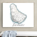 Framed map of Barbados on a wall above a white bench with a light blue towel.