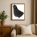 Framed map of Barbados on a wall above a sofa with a plant beside it.