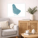 Living room with a map of Barbados on the wall, a couch, and a wooden cabinet.