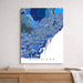 Map of Barcelona on a wall above a wooden shelf
