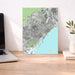 Map of Barcelona on a desk with a laptop and plant