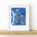 Framed map of Baton Rouge on a white surface with a wooden ledge.